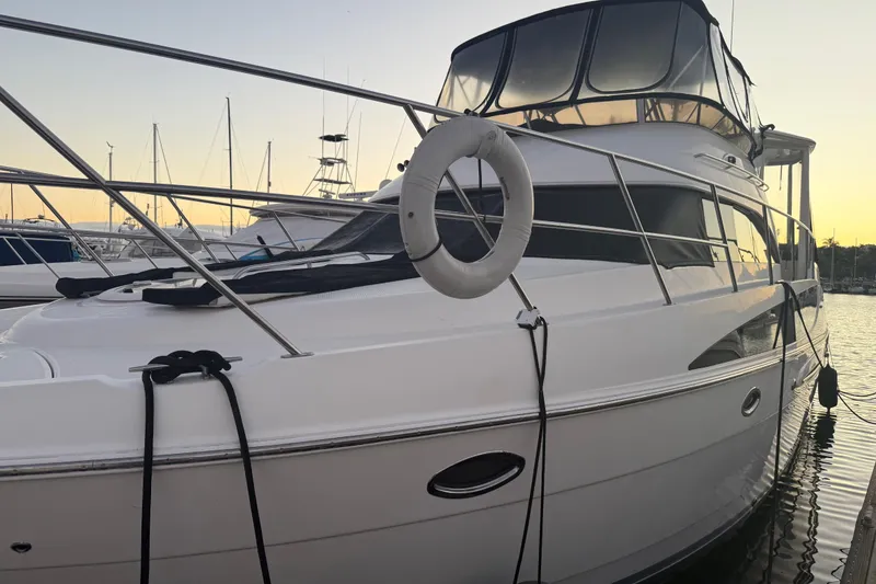 Slide: The Image of 2007 Meridian 459 Motoryacht docked at sunset, featuring sleek design and spacious deck. - 5