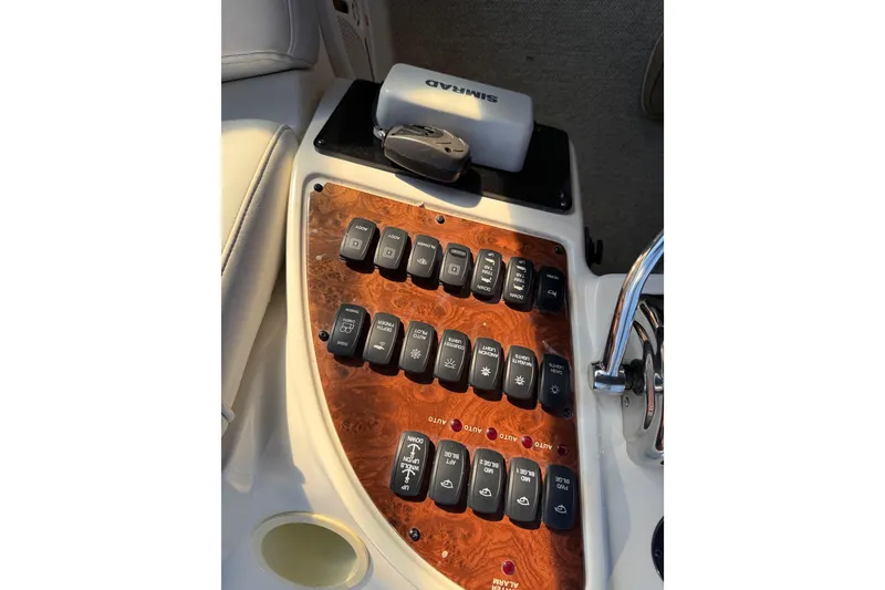 Slide: The Image of Control panel of 2007 Meridian 459 Motoryacht with various switches and a Simrad device. - 52
