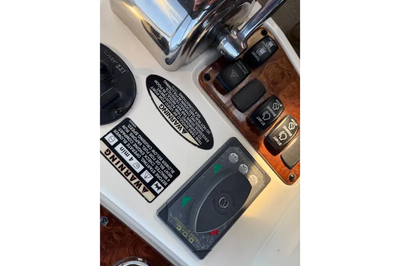 Slide: The Image of Control panel of a 2007 Meridian 459 Motoryacht with warning labels and switches. - 53