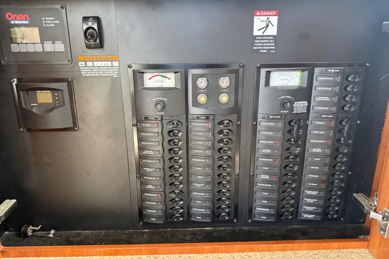 Slide: The Image of Electrical control panel of a 2007 Meridian 459 Motoryacht, featuring Onan e-Series generator controls. - 59
