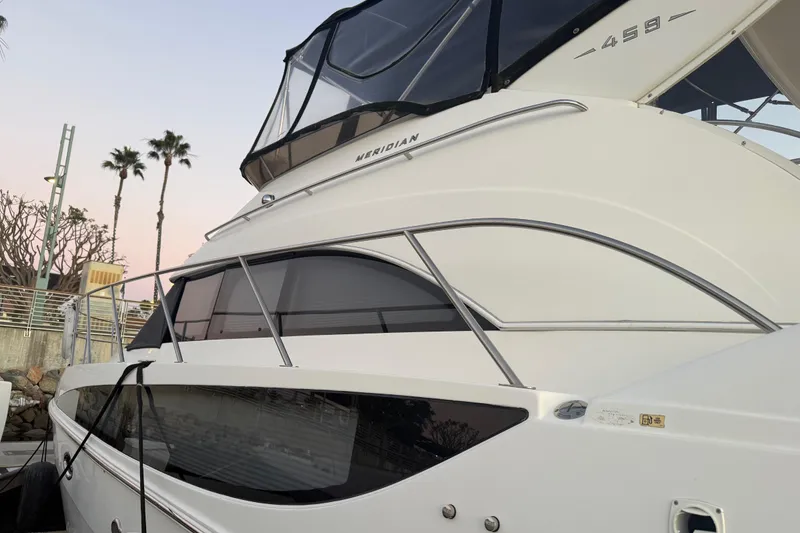 Slide: The Image of 2007 Meridian 459 Motoryacht docked with palm trees in the background. - 6