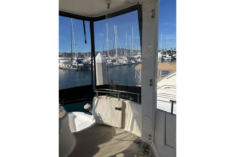 Slide: The Image of 2007 Meridian 459 Motoryacht interior with marina view through clear enclosure. - 60