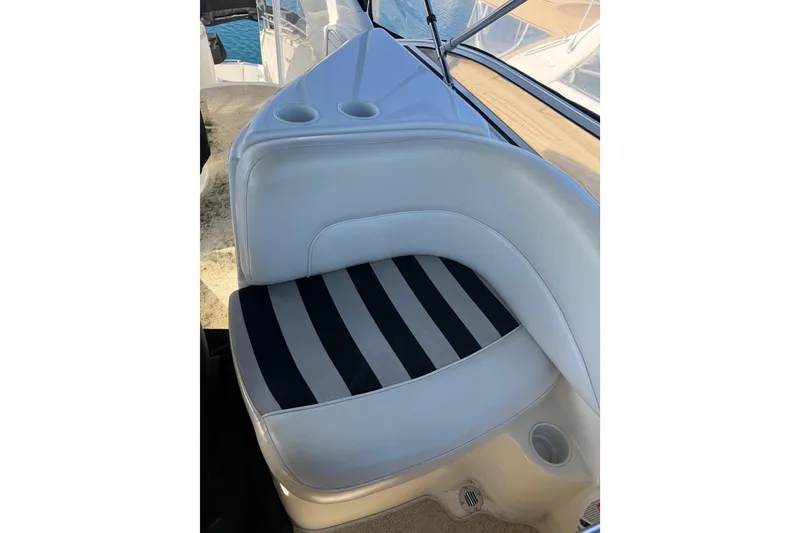 Slide: The Image of 2007 Meridian 459 Motoryacht interior with striped seating and cup holders. - 62