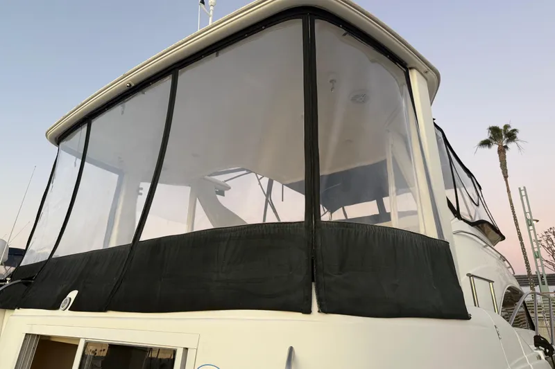 Slide: The Image of 2007 Meridian 459 Motoryacht with enclosed upper deck, palm tree in background. - 8