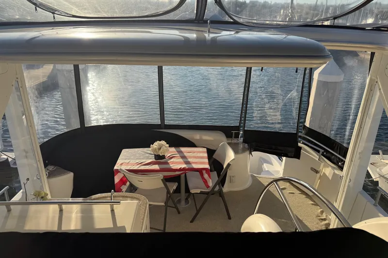 Slide: The Image of 2007 Meridian 459 Motoryacht interior with table, chairs, and water view. - 9