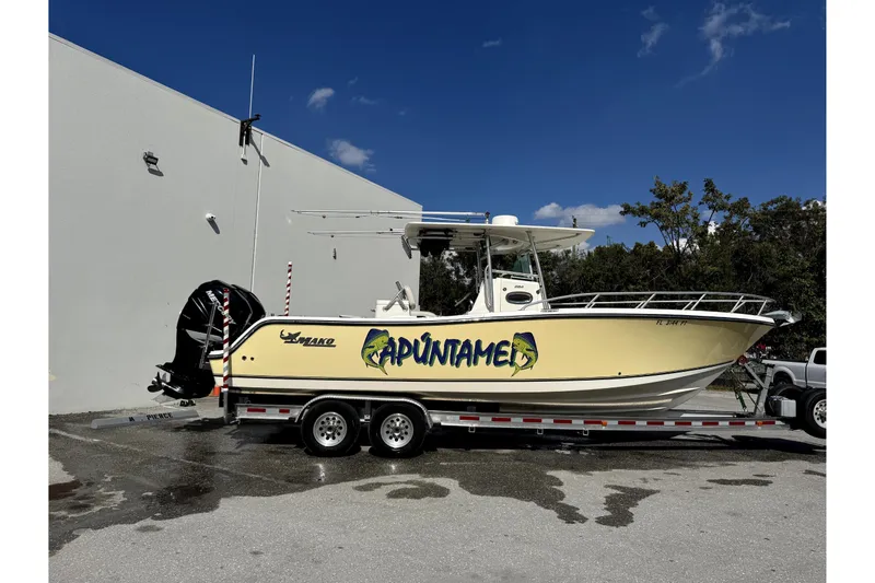 The Image of 2014 Mako 284 Center Console boat on trailer in covered storage. - 0