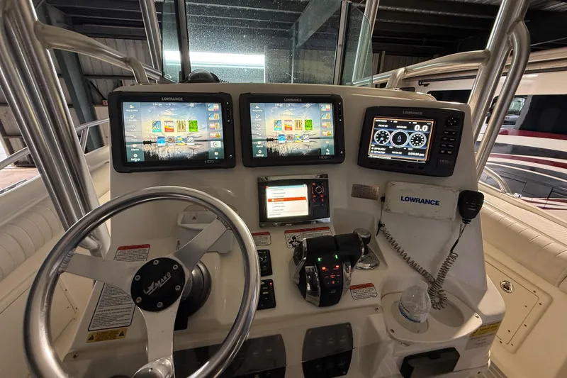 Slide: The Image of 2014 Mako 284 Center Console boat dashboard with Lowrance navigation displays. - 17