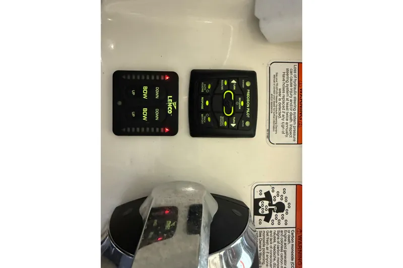 Slide: The Image of Control panel of a 2014 Mako 284 Center Console boat with Lenco trim tab switches. - 18