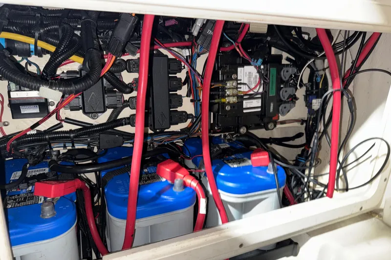 Slide: The Image of Electrical wiring and batteries inside a 2014 Mako 284 Center Console boat. - 27