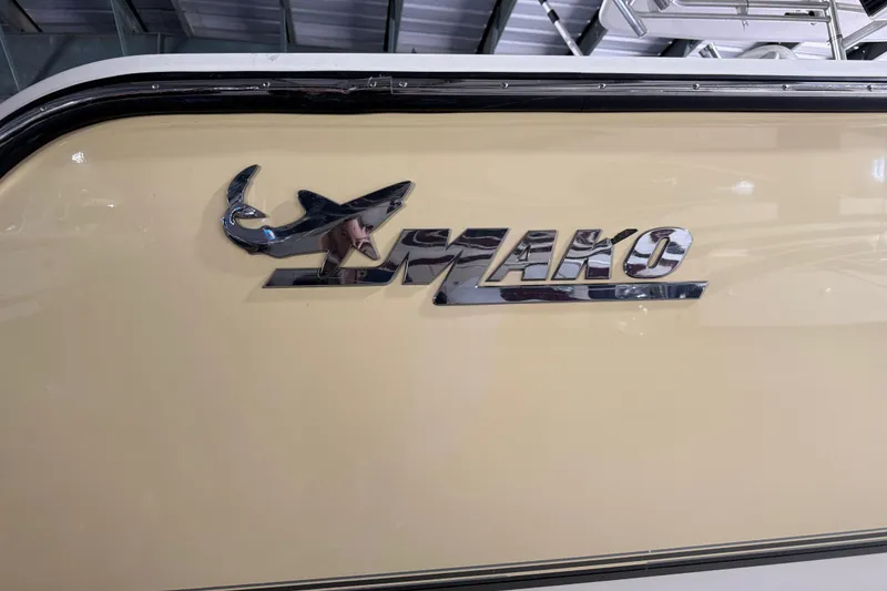 Slide: The Image of 2014 Mako 284 Center Console boat logo on beige hull. - 35