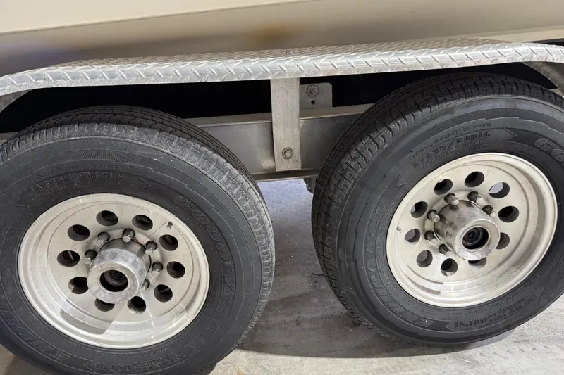 Slide: The Image of Trailer wheels of a 2014 Mako 284 Center Console boat. - 37
