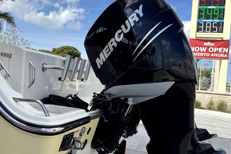 Slide: The Image of 2014 Mako 284 Center Console with Mercury outboard motor at a gas station. - 40