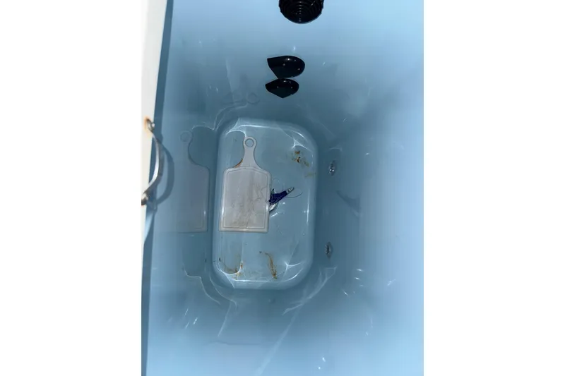 Slide: The Image of Livewell interior of 2014 Mako 284 Center Console boat, showing drainage and cutting boards. - 8