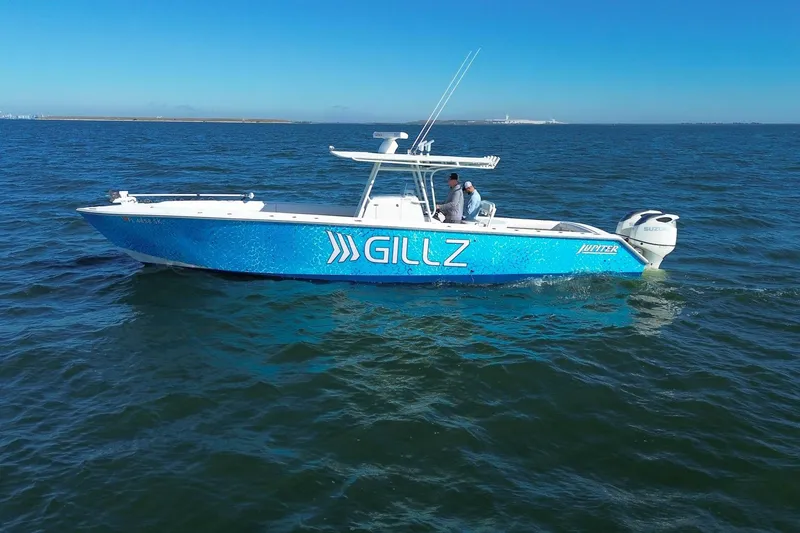 The Image of 2005 Jupiter 38 FS boat with blue hull on open water, featuring "GILLZ" branding. - 0