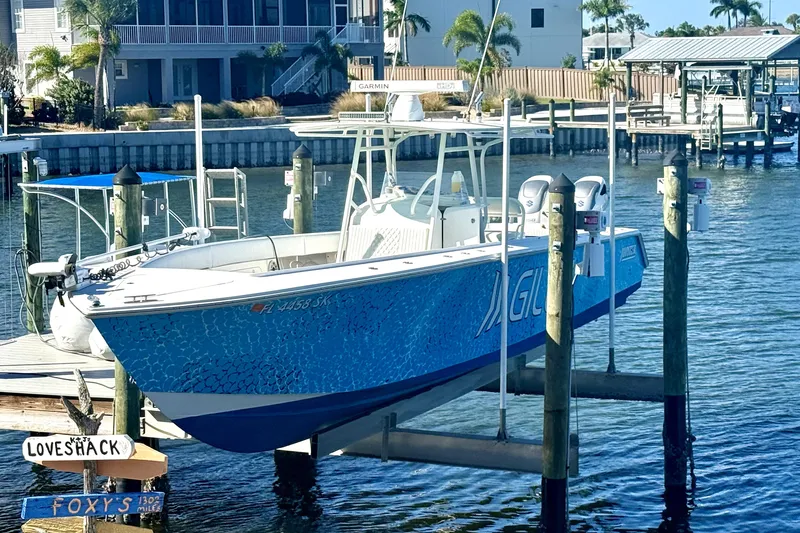 Slide: The Image of 2005 Jupiter 38 FS boat on open water, vibrant blue design, clear sky. - 1