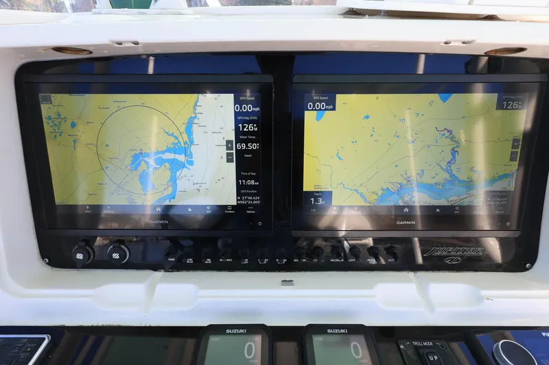 Slide: The Image of Dual Garmin displays on 2005 Jupiter 38 FS boat, showing navigational maps and data. - 14