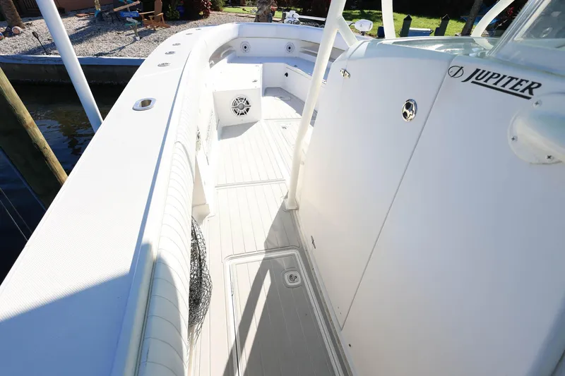 Slide: The Image of 2005 Jupiter 38 FS boat deck, white interior, docked by water. - 17