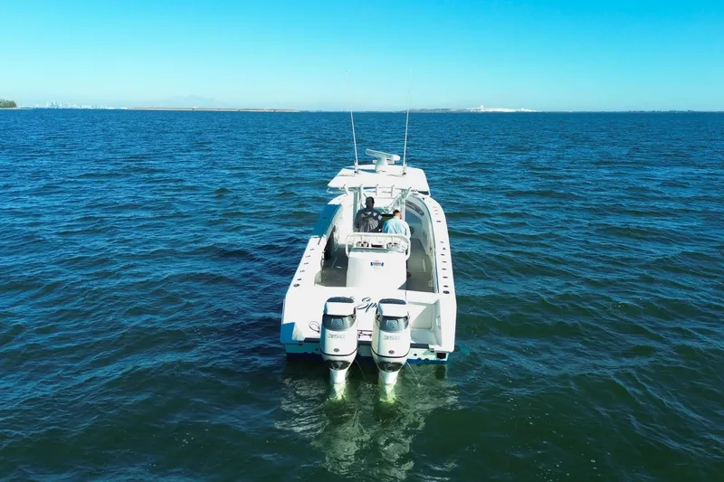 Slide: The Image of 2005 Jupiter 38 FS boat cruising on open water with twin engines. - 2