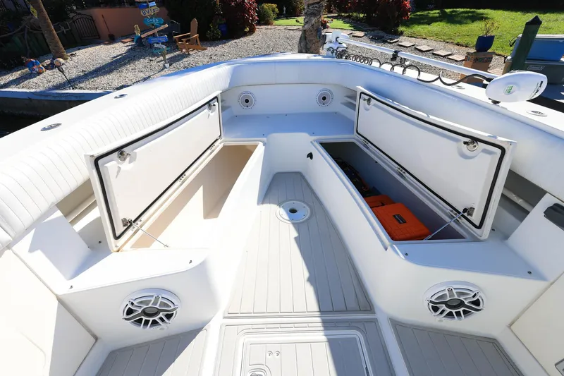 Slide: The Image of 2005 Jupiter 38 FS boat interior with open storage compartments and speakers. - 22