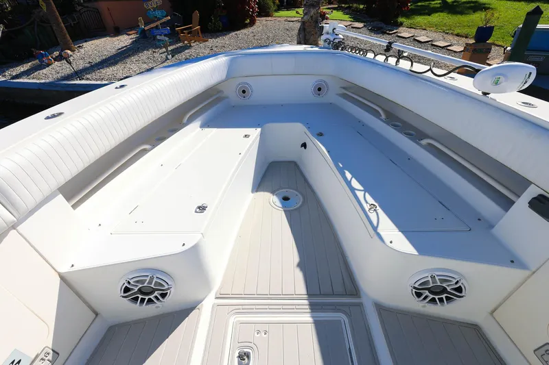 Slide: The Image of 2005 Jupiter 38 FS boat interior with white seating and storage compartments. - 23