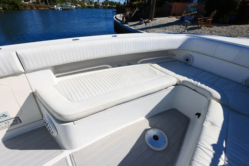 Slide: The Image of 2005 Jupiter 38 FS boat interior with white cushioned seating and waterfront view. - 25