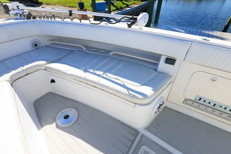 Slide: The Image of Luxurious seating area on a 2005 Jupiter 38 FS boat, docked by the water. - 26