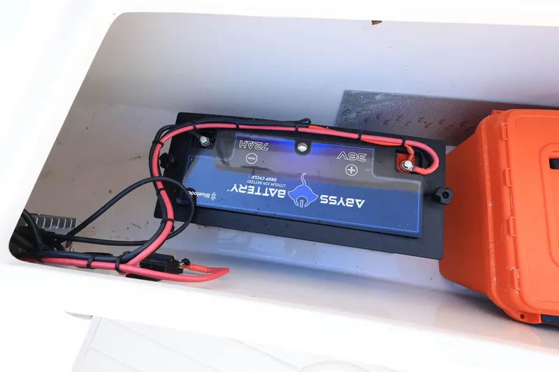 Slide: The Image of Battery compartment of a 2005 Jupiter 38 FS boat with wiring and orange storage box. - 28