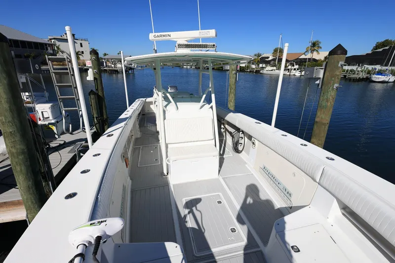 Slide: The Image of 2005 Jupiter 38 FS boat docked at marina under clear blue sky. - 32