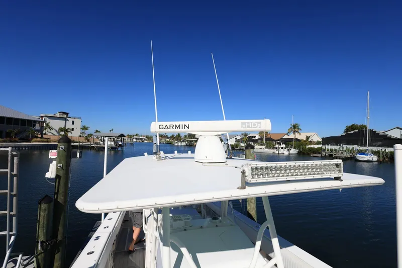 Slide: The Image of 2005 Jupiter 38 FS boat with Garmin radar, docked in a scenic marina. - 34