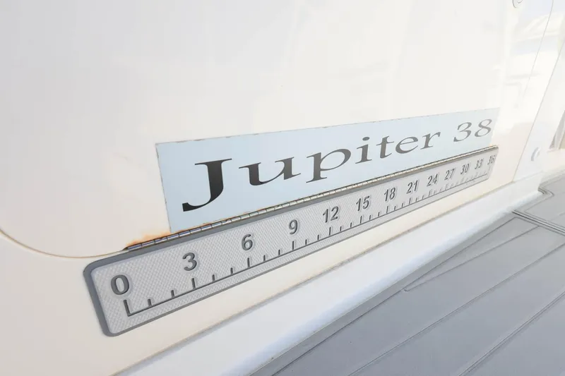 Slide: The Image of Close-up of 2005 Jupiter 38 FS boat nameplate and measurement scale. - 35