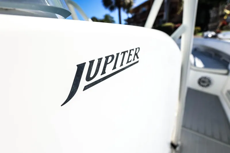 Slide: The Image of Close-up of 2005 Jupiter 38 FS boat logo on white surface. - 36