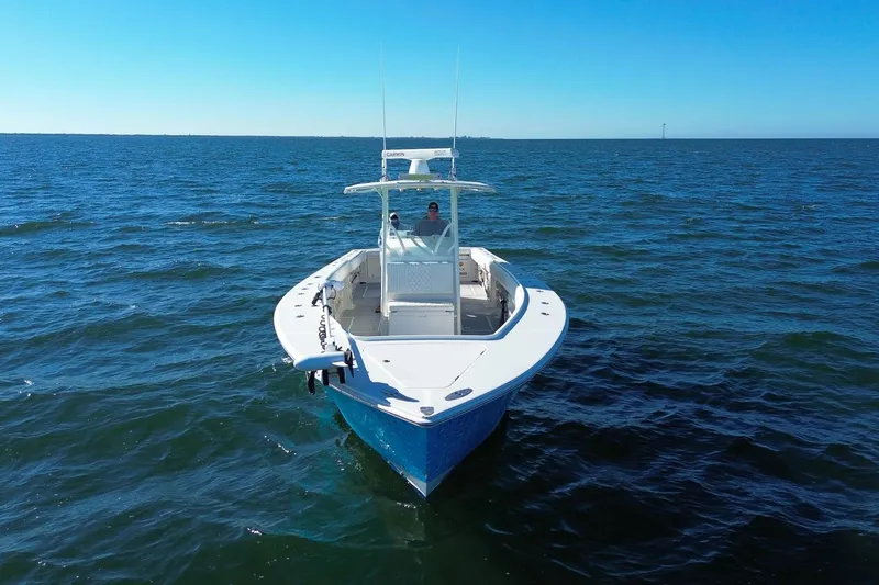 Slide: The Image of 2005 Jupiter 38 FS boat cruising on open water under clear blue skies. - 4
