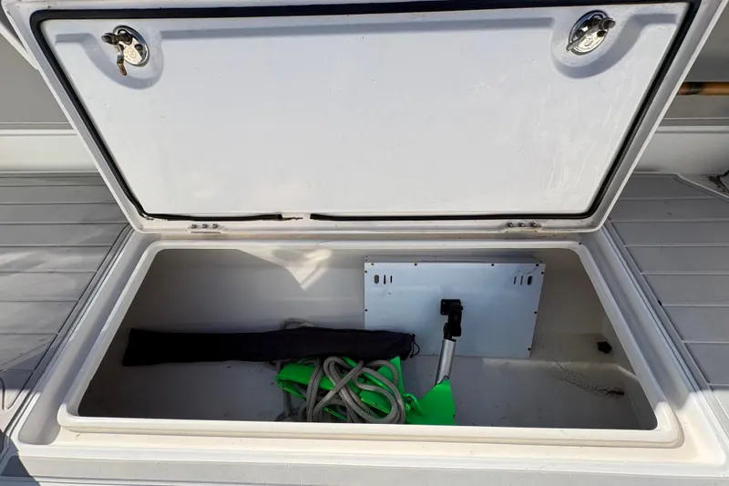 Slide: The Image of Open storage compartment on a 2005 Jupiter 38 FS boat, containing ropes and equipment. - 40