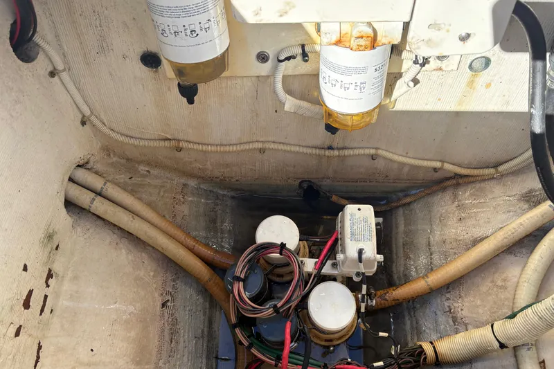 Slide: The Image of Bilge area of a 2005 Jupiter 38 FS boat, showing pumps and wiring. - 41