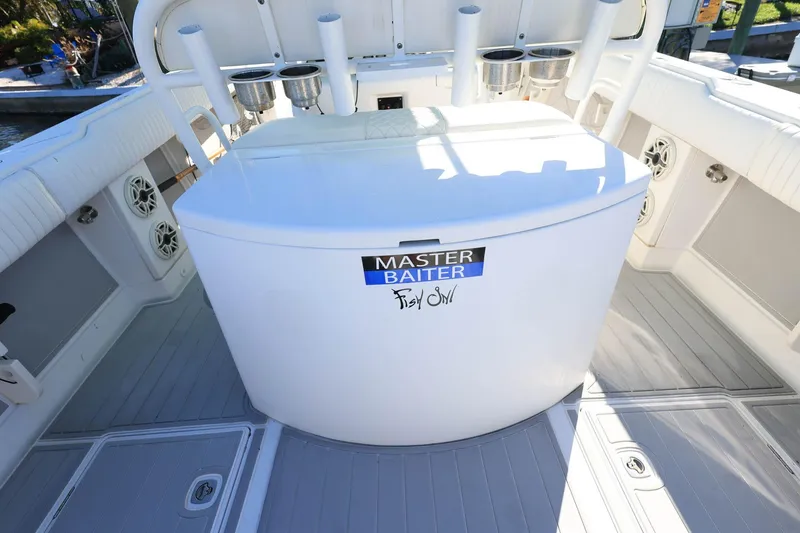 Slide: The Image of 2005 Jupiter 38 FS boat deck with fishing rod holders and storage compartment. - 8