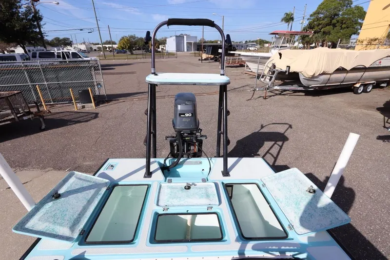Slide: The Image of 1996 Silver King Signature 16 boat with open hatches and outboard motor in a marina. - 11