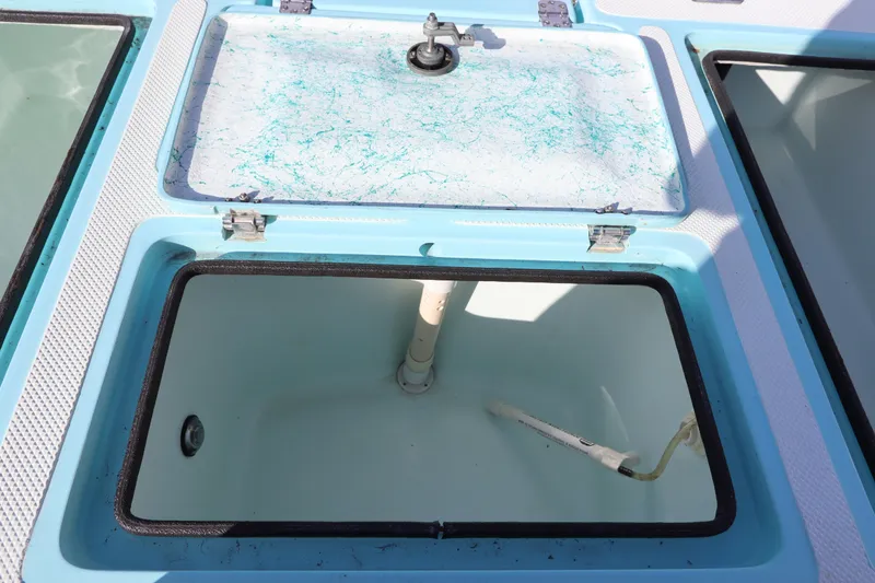 Slide: The Image of Open hatch of a 1996 Silver King Signature 16 boat, showing interior compartment. - 12