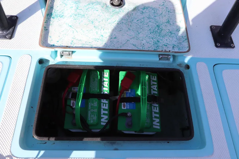 Slide: The Image of Open battery compartment of 1996 Silver King Signature 16 boat with Interstate batteries. - 13