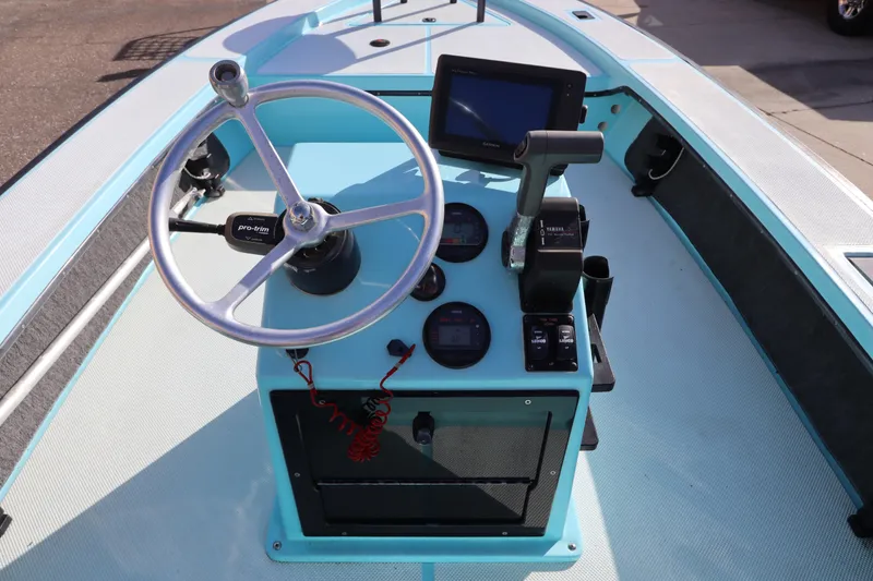 Slide: The Image of 1996 Silver King Signature 16 boat console with steering wheel and navigation controls. - 15