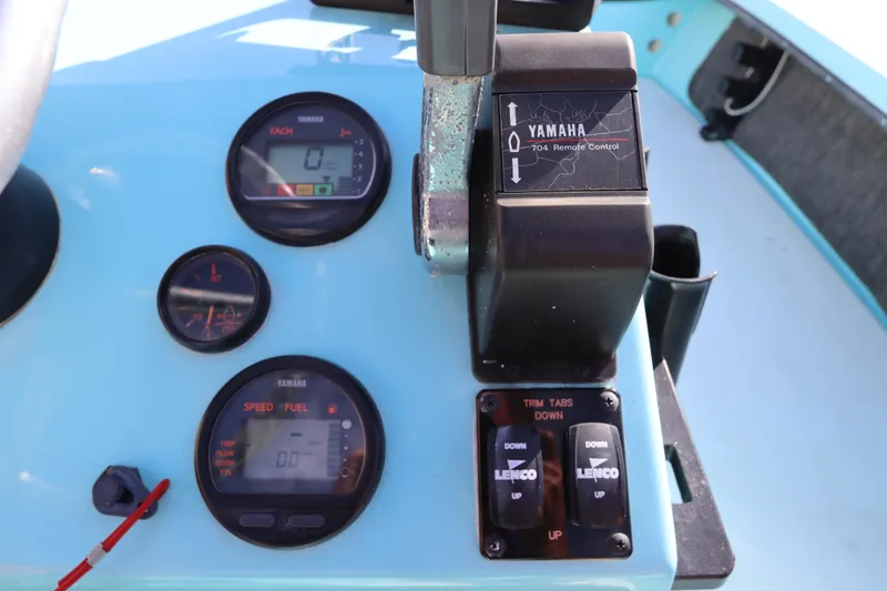 Slide: The Image of 1996 Silver King Signature 16 boat dashboard with Yamaha controls and gauges. - 16