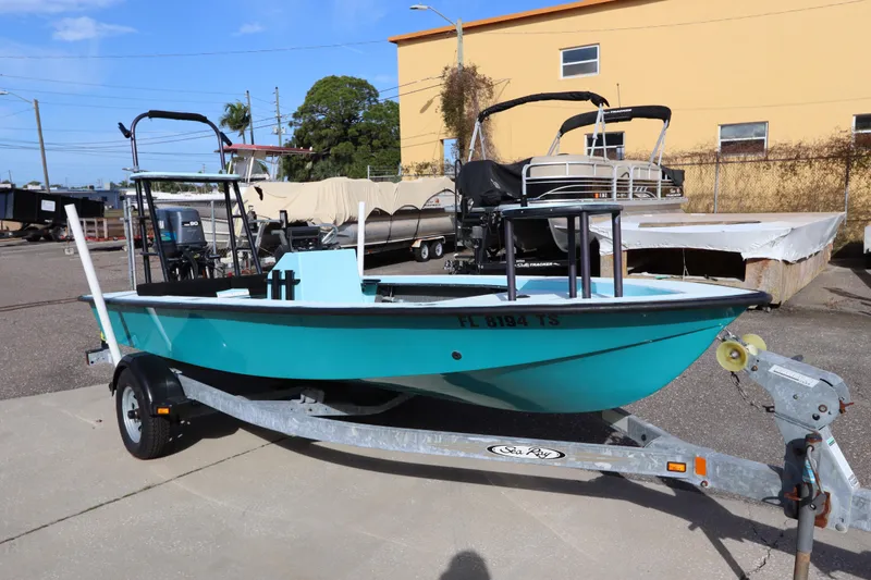 Slide: The Image of 1996 Silver King Signature 16 boat on trailer, turquoise hull, parked outdoors. - 2