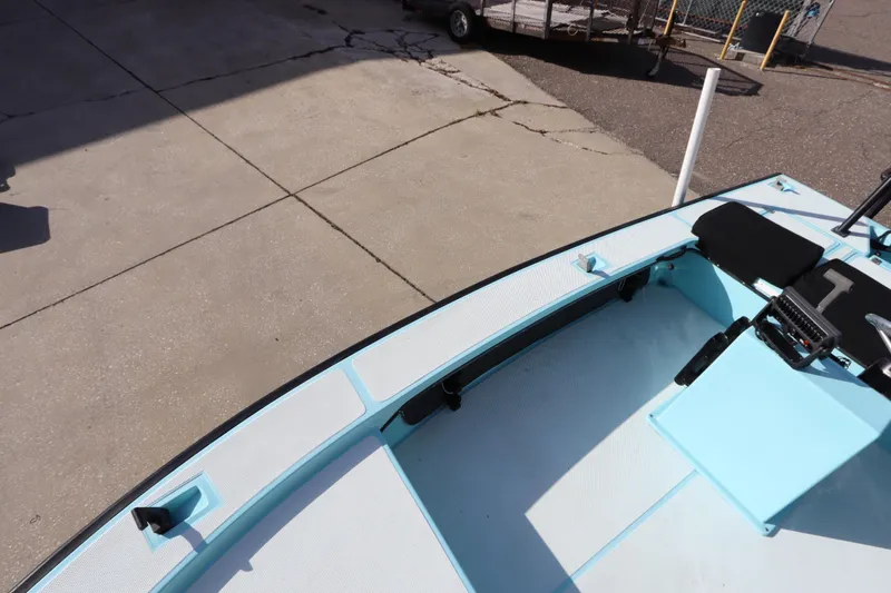 Slide: The Image of 1996 Silver King Signature 16 boat interior with light blue deck and seating. - 23