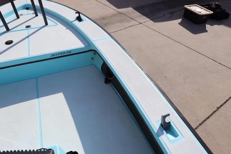 Slide: The Image of 1996 Silver King Signature 16 boat deck, light blue and white, docked on concrete. - 24