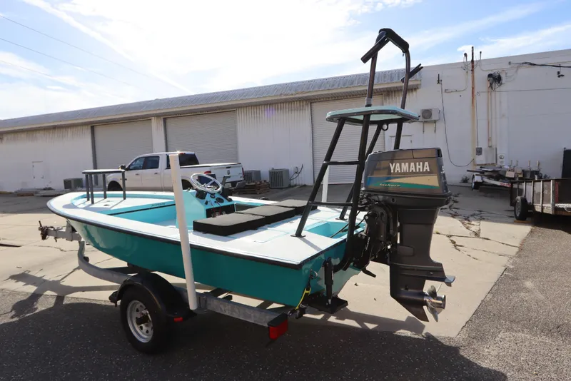 Slide: The Image of 1996 Silver King Signature 16 boat with Yamaha motor on trailer, parked outdoors. - 5