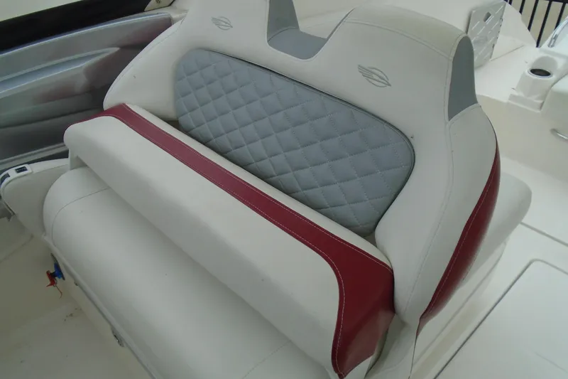 Slide: The Image of 2013 Chaparral 327 SSX boat interior with white seating and red accents. - 10