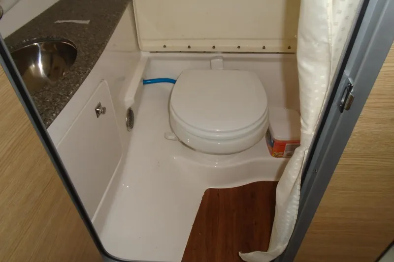 Slide: The Image of Interior of 2013 Chaparral 327 SSX boat with wooden flooring and storage area. - 17