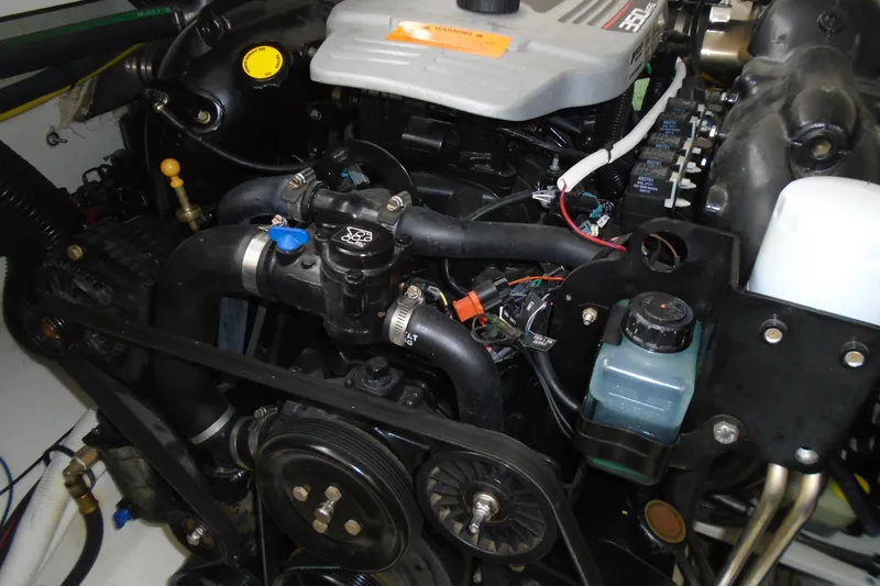 Slide: The Image of 2013 Chaparral 327 SSX boat engine compartment with dual engines visible. - 32