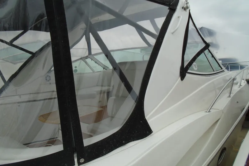 Slide: The Image of 2013 Chaparral 327 SSX boat seat with white, red, and gray upholstery design. - 39