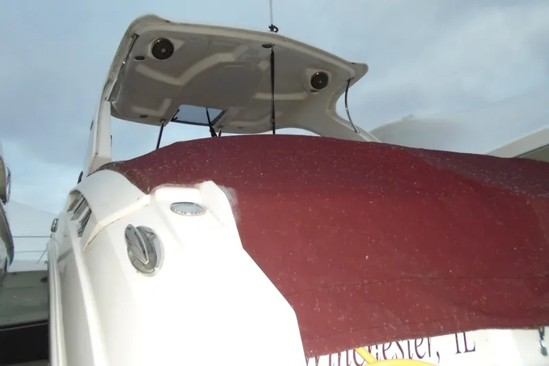 Slide: The Image of 2013 Chaparral 327 SSX boat with maroon cover and sleek design. - 5