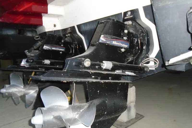 Slide: The Image of 2013 Chaparral 327 SSX boat with red cover and white hull, viewed from below. - 7